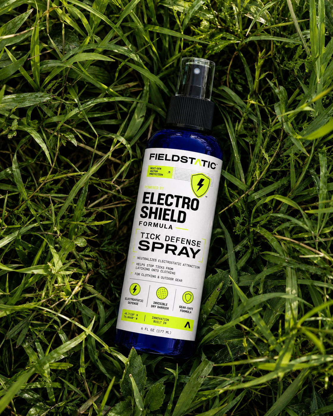 Fieldstatic Electro Shield tick defense spray bottle lying in green grass
